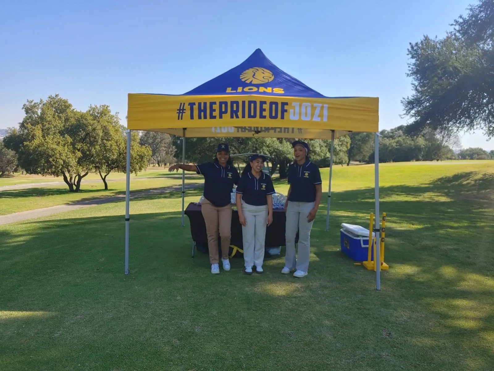 Lions #ThePrideOfJozi gazebo with hosts on the course