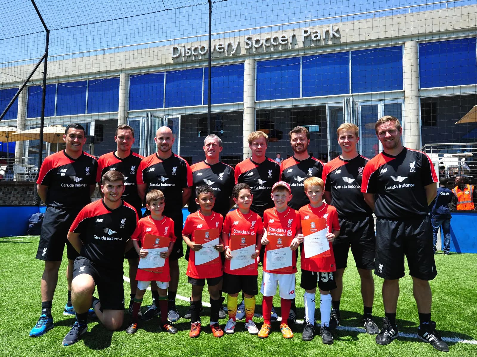 Liverpool FC coaches and young players line up at Discovery Soccer Park