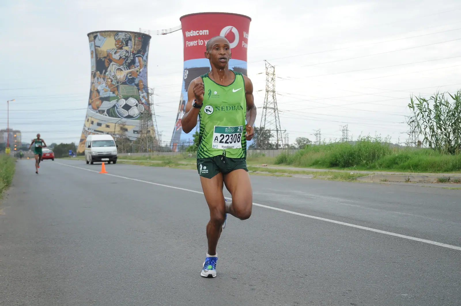 A lead runner passes the Orlando Towers