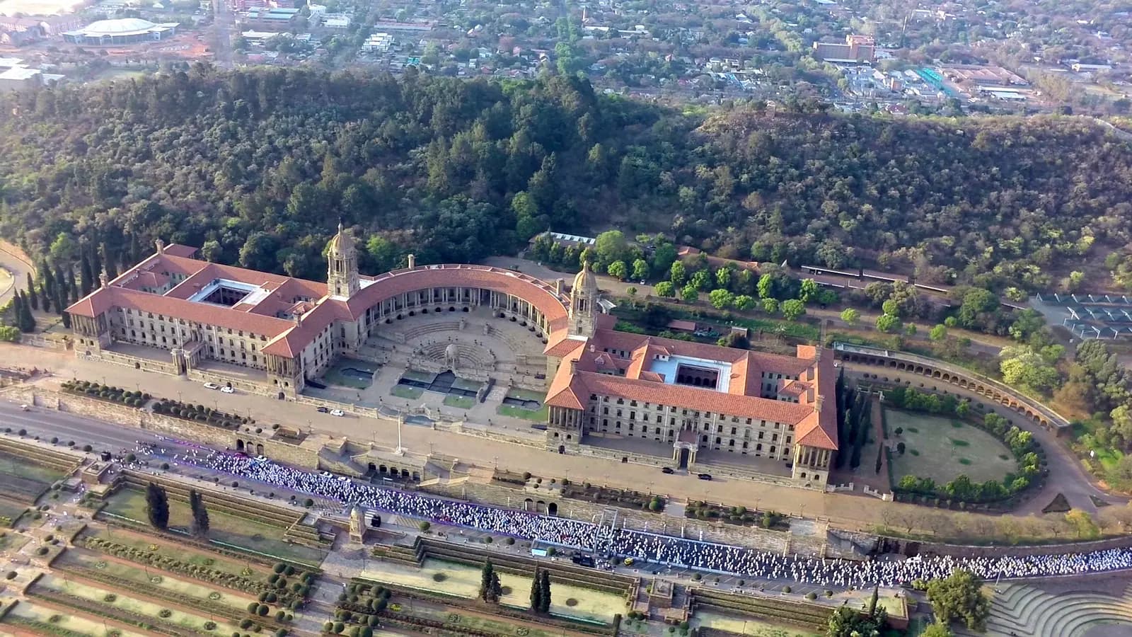 Aerial view of walkers on the lawns of the Union Buildings
