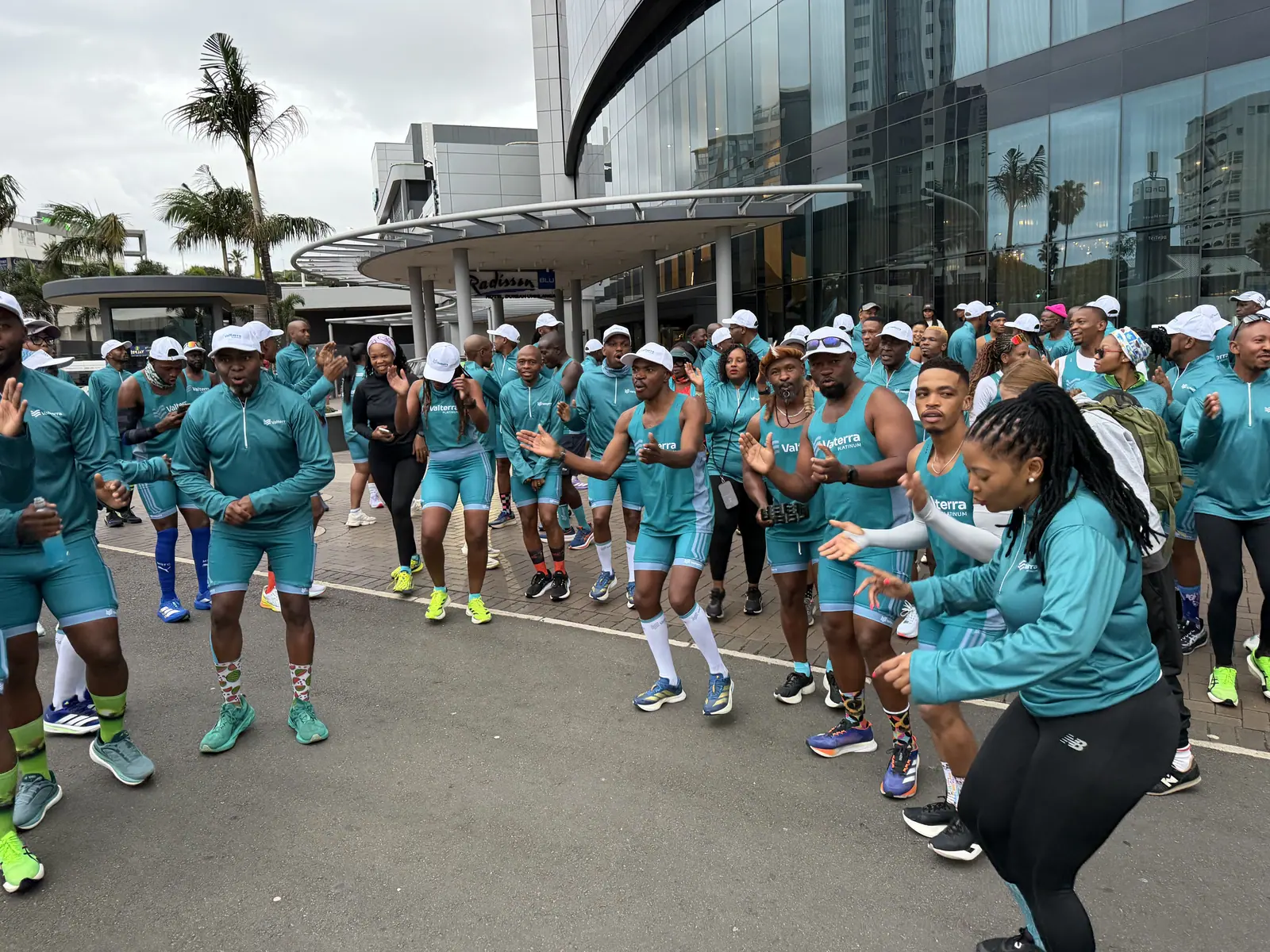 Valterra Platinum team in teal kit warms up outside a hotel