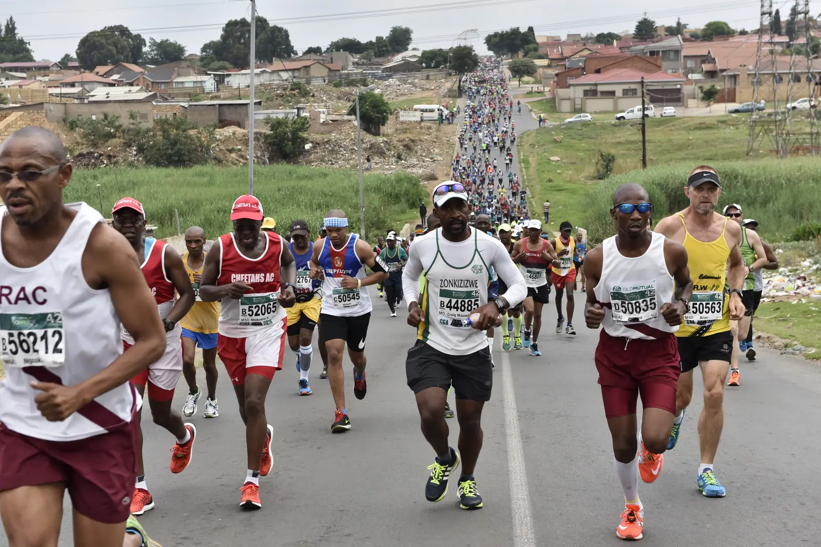 Runners on the road through Soweto during the Soweto Marathon